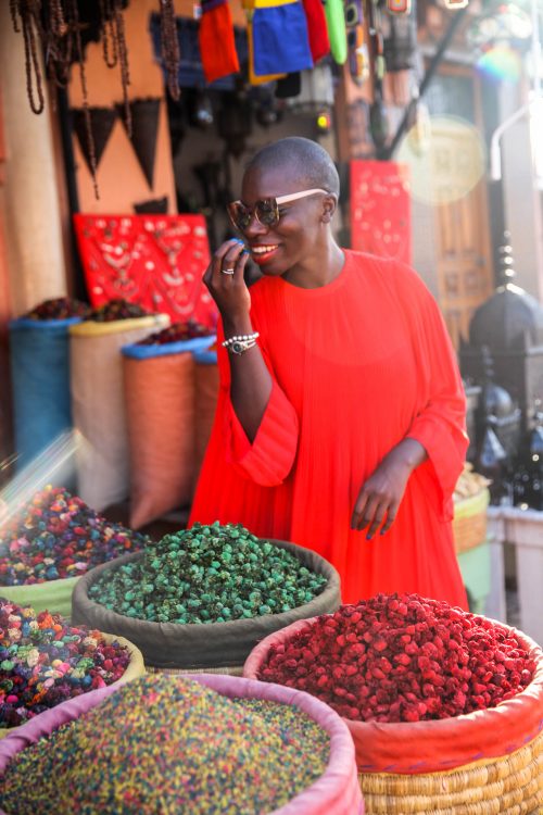 Jessica at a market in Marrakech, Morocco smelling the spices sold at a stall